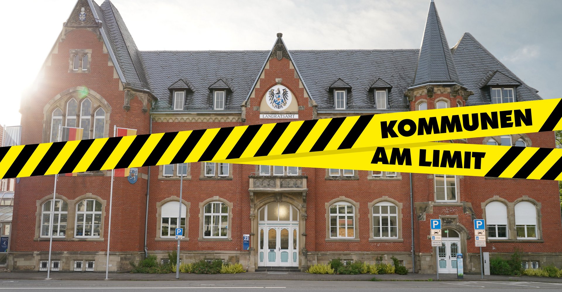 Landratsamt in St. Wendel mit einer Grafik eines Absperrbands mit der Aufschrift Kommunen am Limit